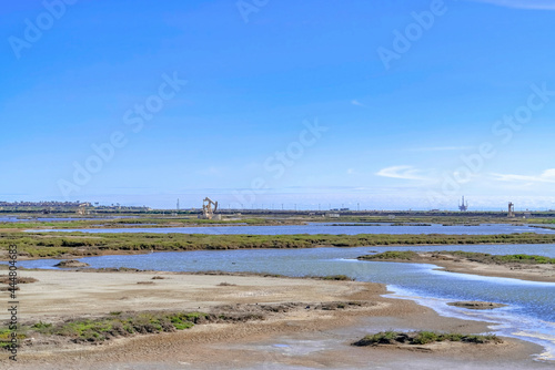 Bolsa Chica Ecological Reserve wetland landscape with distant oil rig machinery