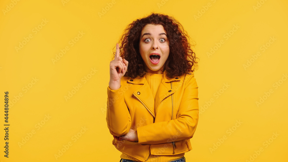 amazed young woman in leather jacket having idea isolated on yellow amazed young woman in leather jacket having idea isolated on yellow
