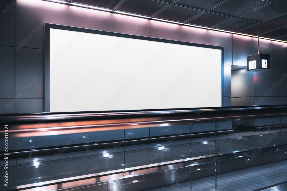 A huge rectangular empty billboard mockup next to travelator in a modern airport departure area; a white blank poster template indoors of a terminal of public transport building near a moving walkway A huge rectangular empty billboard mockup next to travelator in a modern airport departure area; a white blank poster template indoors of a terminal of public transport building near a moving walkway