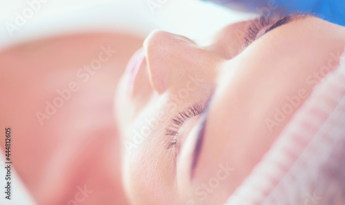 Permanent makeup for eyebrows. Closeup of beautiful woman with thick brows in beauty salon.