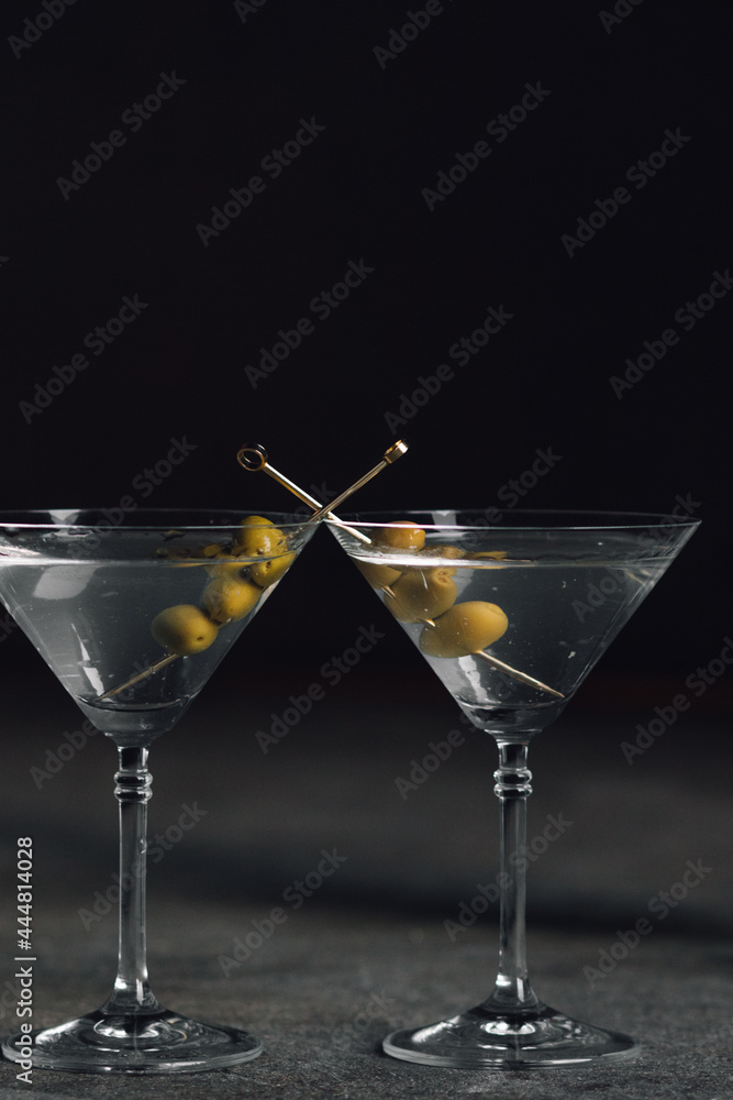 two martini with olives on gold cocktail picks 