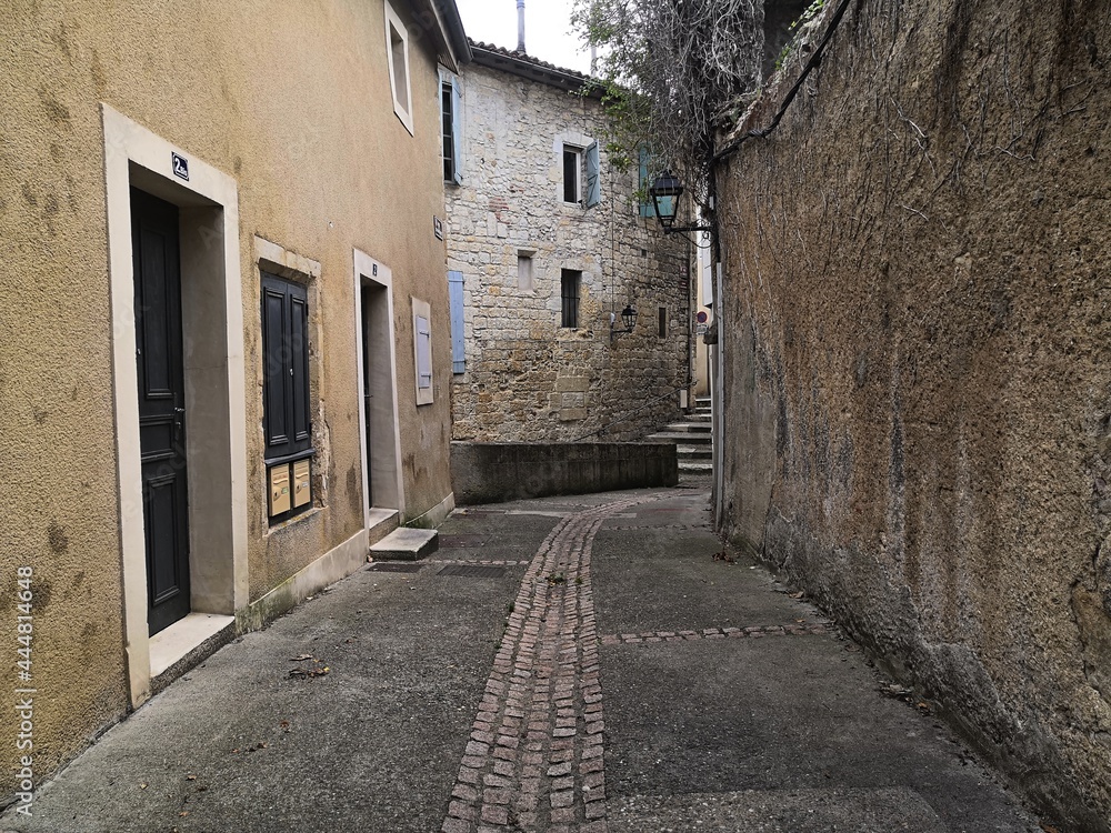 In the heart of the city, narrow, cobbled lane, with stone walls, old wooden shutters