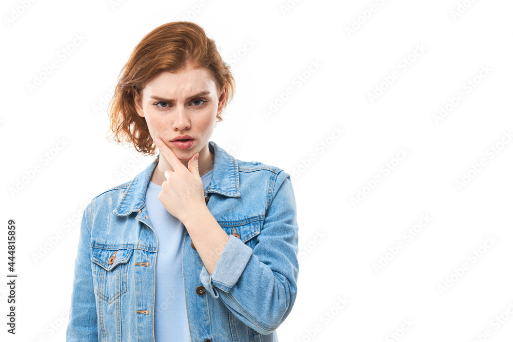 Portrait of red haired dreamy lovely lady, youth. Redhead woman in blue jeans displeased thinks, chooses, decides, dilemmas, isolated white background. Girl student is unhappy Portrait of red haired dreamy lovely lady, youth. Redhead woman in blue jeans displeased thinks, chooses, decides, dilemmas, isolated white background. Girl student is unhappy