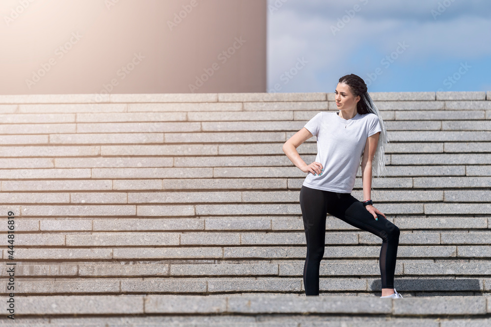 Fitness girl jumping on stairs during her morning workout. Urban sport concept Fitness girl jumping on stairs during her morning workout. Urban sport concept