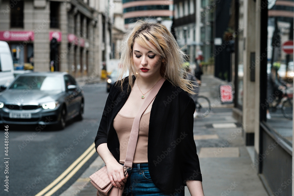 Beautiful blonde urban girl walking around the streets of London.