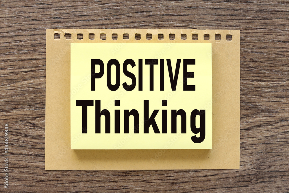 Think Positive, text on a wooden table, on a bright sticker
