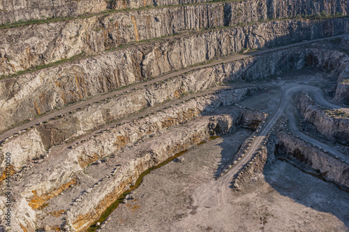 Dolomite quarry.Photo from the top. Industrial terraces in a mining quarry. Aerial view of open pit mining. Excavation of the Dolomite Mine. Extractive industry. Finland. Porgas, Turku Archipelago.