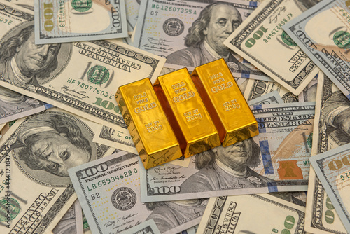 large bank gold bars bullions on dollars bills