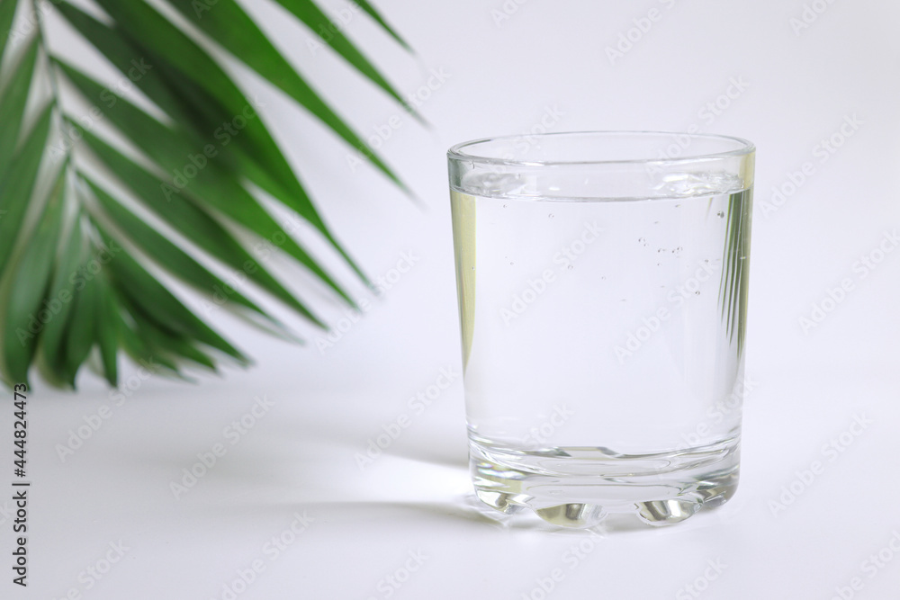 Glass of pure water on the table. Detox and dieting concept. Close-up, selective focus Glass of pure water on the table. Detox and dieting concept. Close-up, selective focus