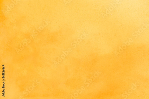 Bright yellow plastered textured background