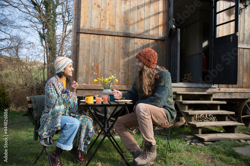 Happy young couple eating outside tiny cabin rental photo
