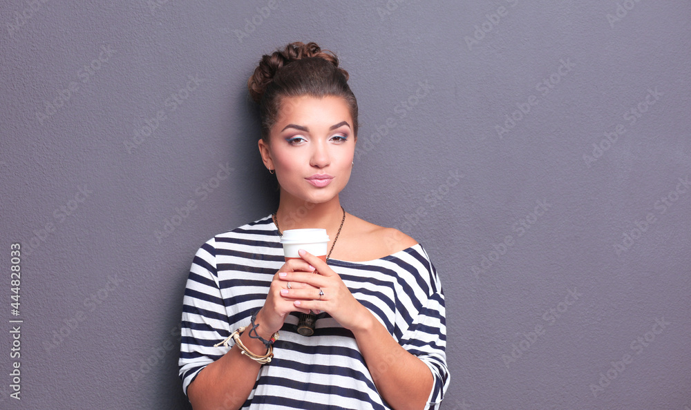 Portrait of young woman with cup tea or coffee