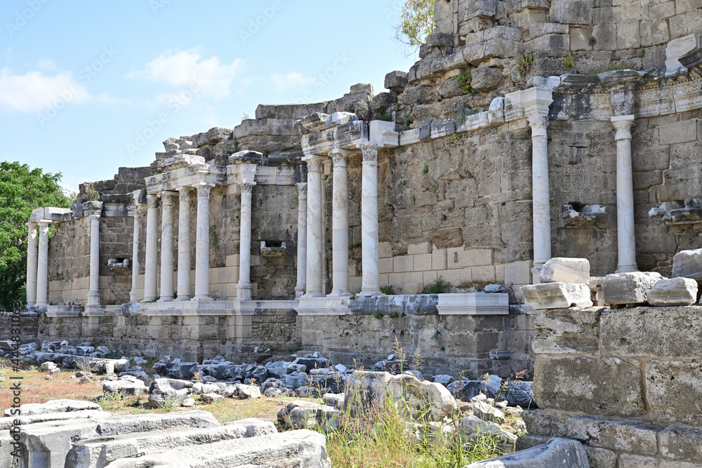 The ruins of an old stone aqueduct with white columns