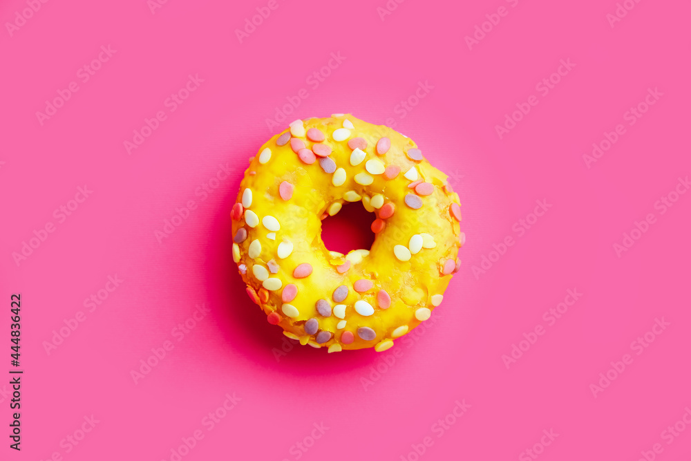 Yellow sugar glazed donut on colorful purple background. Yellow sugar glazed donut on colorful purple background.