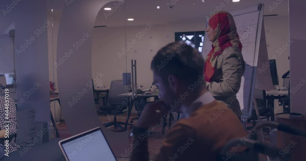 Businesswoman in wheelchair having business meeting with team at modern office Businesswoman in wheelchair having business meeting with team at modern office