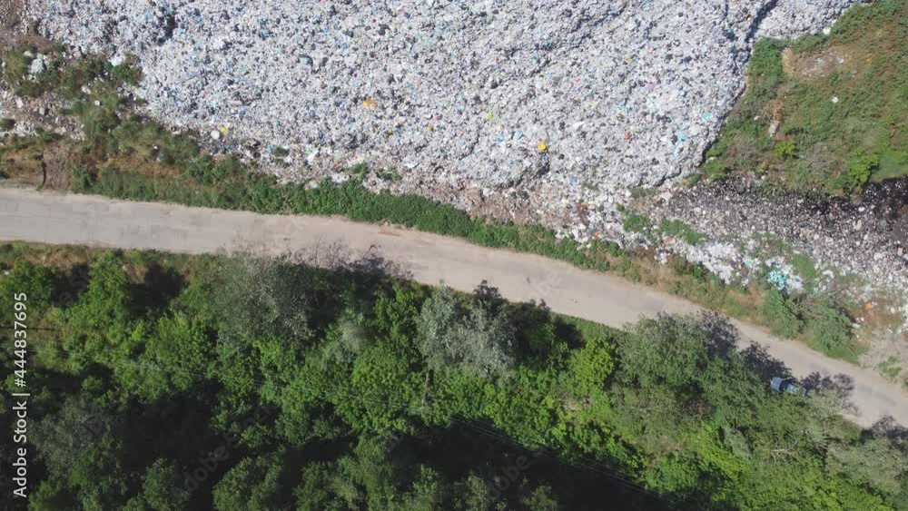 Aerial view of huge rubbish dump. Trash and garbage landfill. Ecology problem, nature pollution. Consumerism economy cons. Aerial view of huge rubbish dump. Trash and garbage landfill. Ecology problem, nature pollution. Consumerism economy cons.
