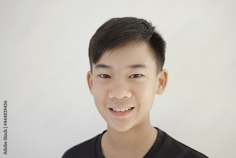 Head shot portrait of happy, confident and healthy mixed race Asian preteen teen boy smiling face, youth day Head shot portrait of happy, confident and healthy mixed race Asian preteen teen boy smiling face, youth day
