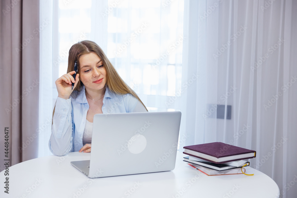 A pensive student writes notes, studies or works at home, a seri A pensive student writes notes, studies or works at home, a seri