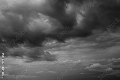 Epic Dramatic Storm sky, dark grey rainy clouds with wind, abstract background texture, thunderstorm. Black and white photo 