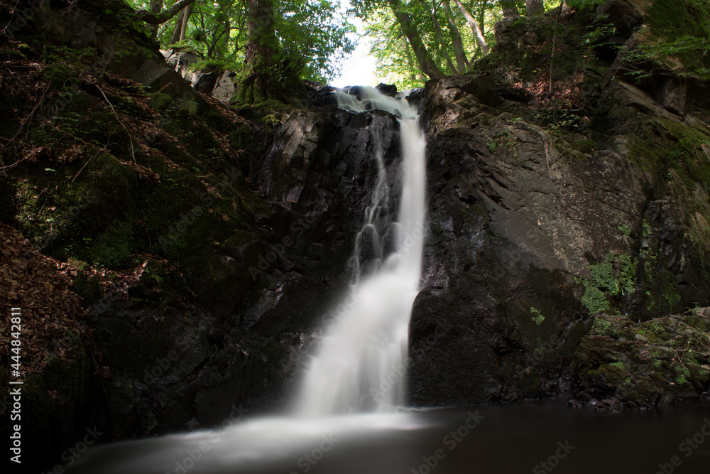 Small waterfall in Forsakar, Southern Sweden, surrounded by plants, shrubs, and bushes. Long-exposure shot. Small waterfall in Forsakar, Southern Sweden, surrounded by plants, shrubs, and bushes. Long-exposure shot.