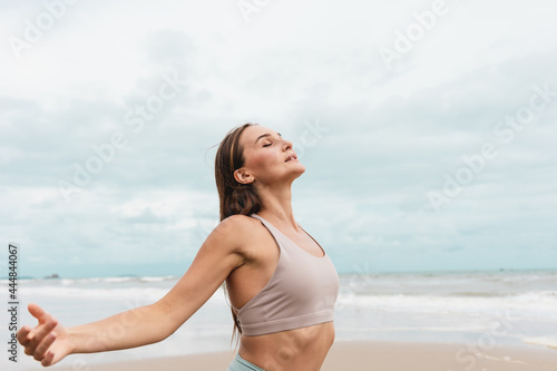 Healthy woman in sportswear relax after a workout at the beach.