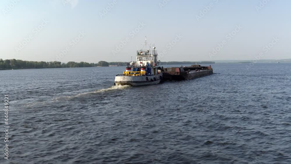 Empty cargo ship barge floats on the river on the background of the city 4k Empty cargo ship barge floats on the river on the background of the city 4k
