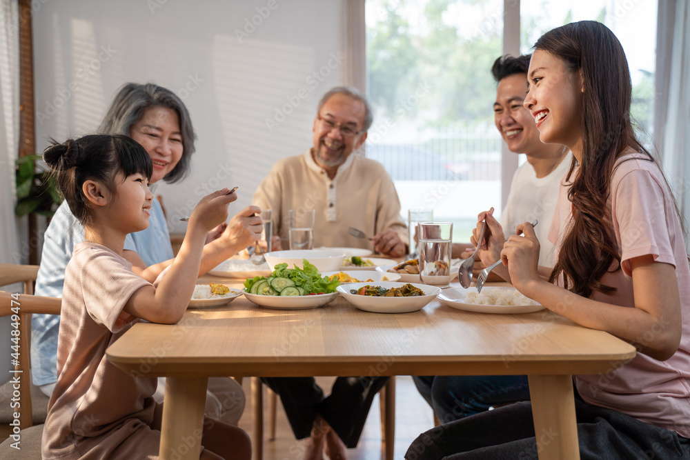 Asian Big happy family spend time have lunch on dinner table together. Asian Big happy family spend time have lunch on dinner table together.