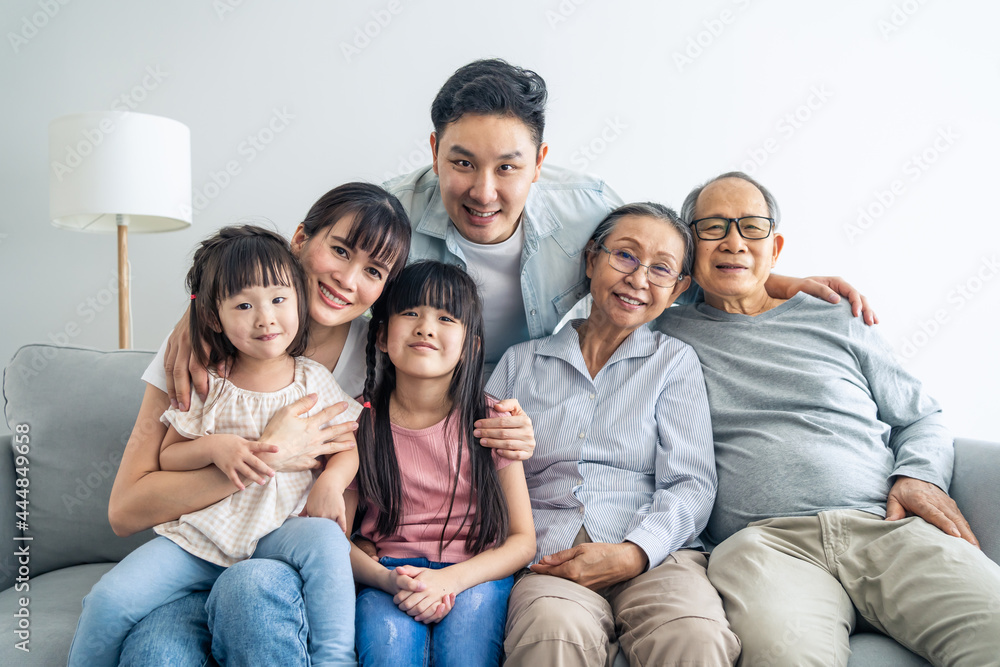 Portrait of Asian happy family sit on sofa and smile, look at camera. Portrait of Asian happy family sit on sofa and smile, look at camera.