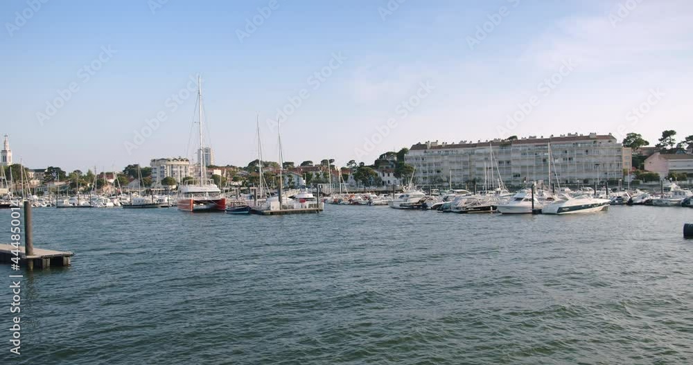 City pier with luxury sailboats on calm day, panning shot City pier with luxury sailboats on calm day, panning shot