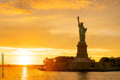 The Statue of Liberty at New York city during sunset © Kenishirotie
