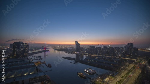 Sunset timelapse video of Bolte Bridge with Melbourne Star Observation Wheel at District Docklands in Melbourne CBD, Australia