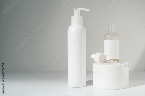 Three jars of cosmetics stand on a white background.