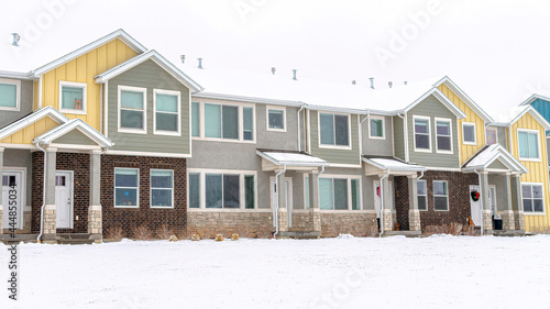 Pano Apartment houses in a snowy neighborhood with cloudy sky background in winter