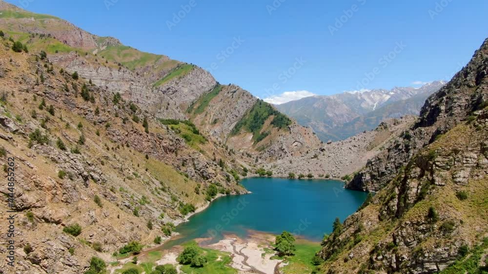 Aerial View Of The Blue Water Of Urungach Lake On The Middle Of The Mountains In Uzbekistan. Aerial View Of The Blue Water Of Urungach Lake On The Middle Of The Mountains In Uzbekistan.