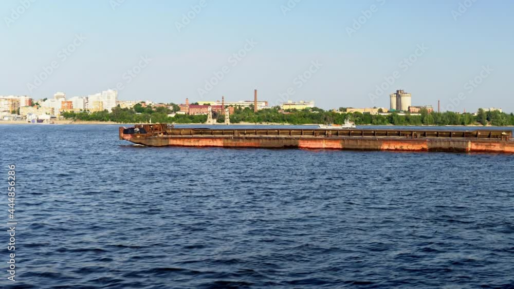 Empty cargo ship barge floats on the river on the background of the city 4k Empty cargo ship barge floats on the river on the background of the city 4k