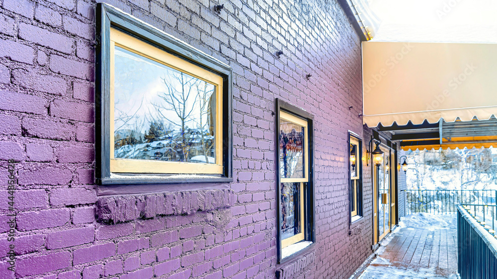 Fototapeta premium Pano Building exterior with awning over the snowy wooden deck at the entrance