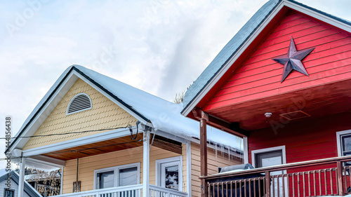 Foto Pano Two storey homes with balconies snowy gable roofs and garages at the facade