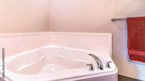Fototapeta Naklejka Na Ścianę i Meble -  Pano Shiny clean bathtub inside bathroom of residential house with plain white wall