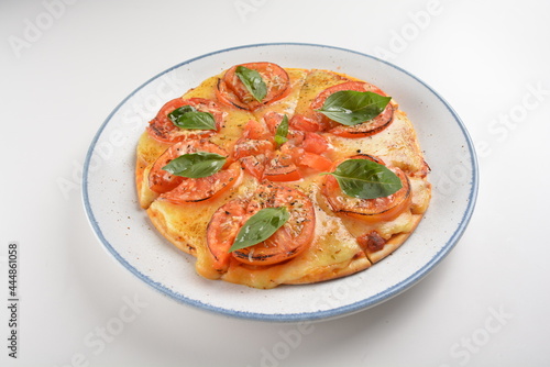 baked cheesy pizza with vegetarian margherita and tomato in white background western halal menu