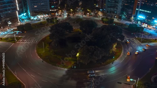 Aerial hyperlapse of driving cars at renai roundabout in taipei, Taiwan. Traffic on road surrounded by lighting skyscraper buildings,taiwan photo