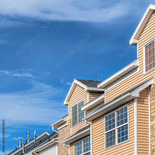 Square Clouds and blue sky on a sunny day over townhouses in the valley neighborhood