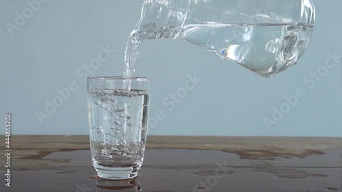 slow motion of pouring water from jug into glass. Full HD