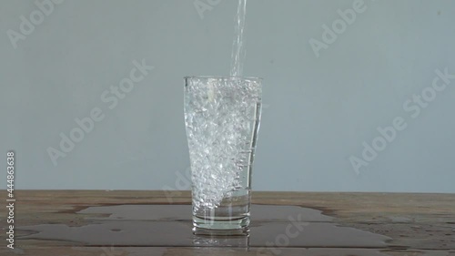 slow motion of pouring water into tall glass. Full HD