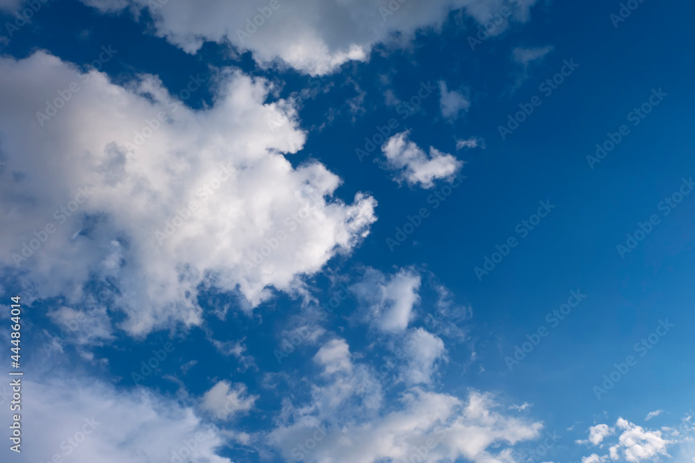 Soft white clouds against blue sky background..