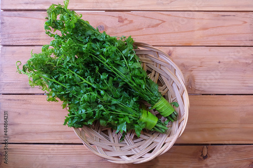 фотографія Bunch of Paco Fern, Small Vegetable fern, Vegetable fern in bamboo baskets