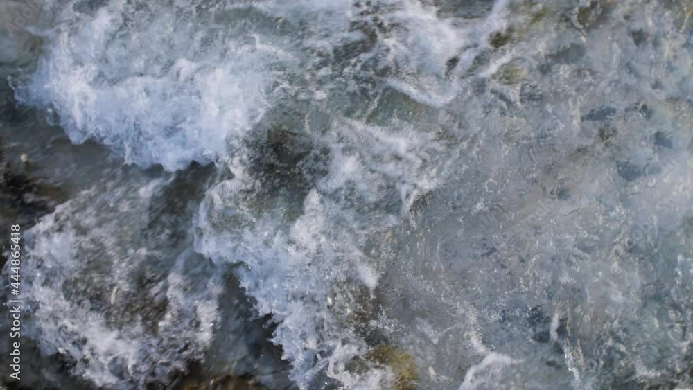 Clear water flowing down a manmade stream, river or canal in a mountain village. Close up of fresh water foaming. 4K. Clear water flowing down a manmade stream, river or canal in a mountain village. Close up of fresh water foaming. 4K.