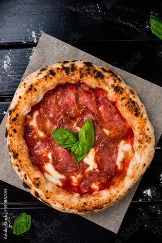 Pizza pepperoni, mozzarella on a black table background