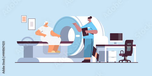 doctor with senior patient in tomography machine magnetic resonance imaging mri equipment hospital radiology