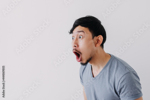 Shocked and surprised face of Asian man in isolated on white background. photo