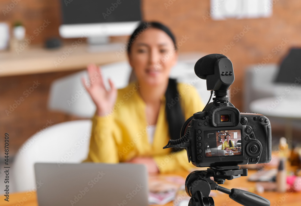 Asian beauty blogger recording video at home
